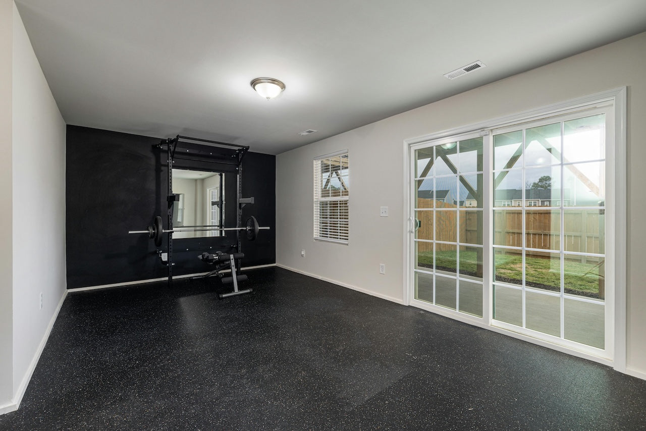 Apartment gym mirrors brightening a small home fitness area