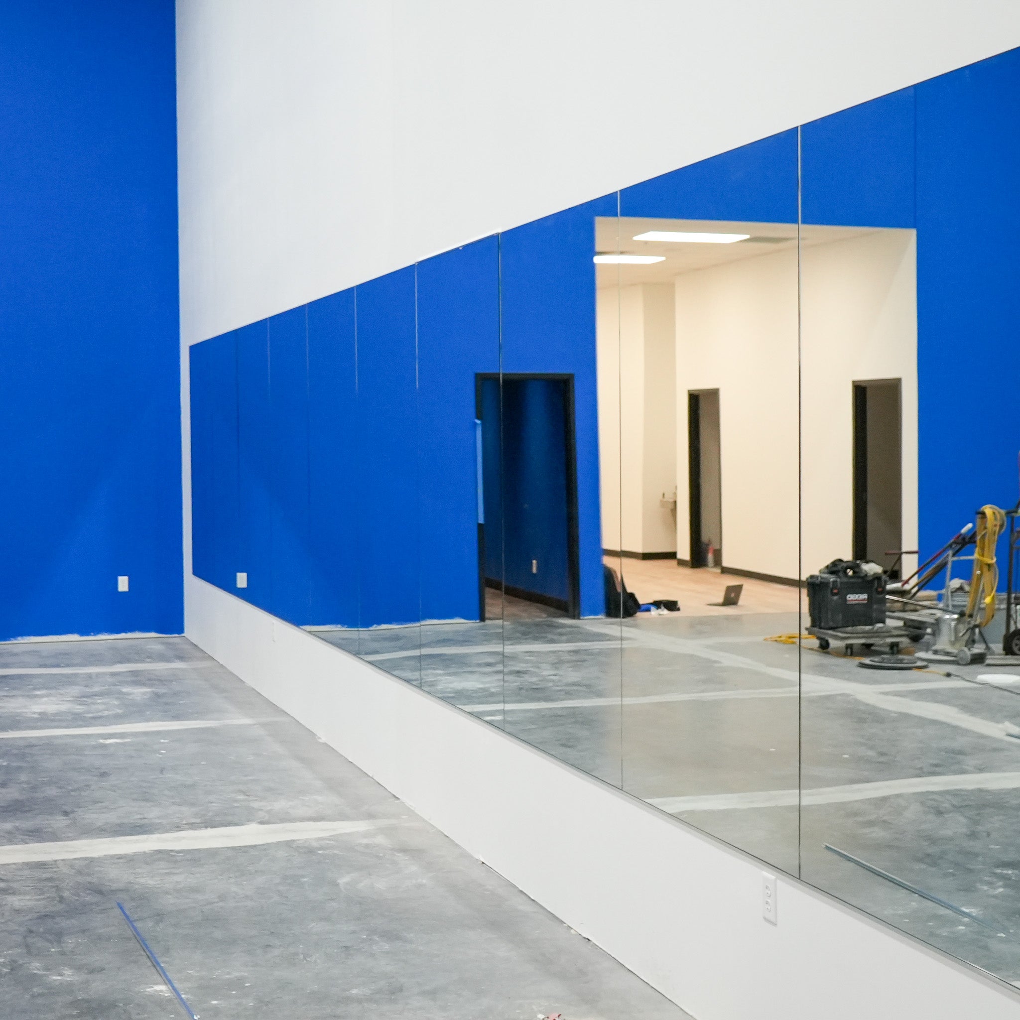 Modern Fitness interior with Gym mirrors and blue walls 