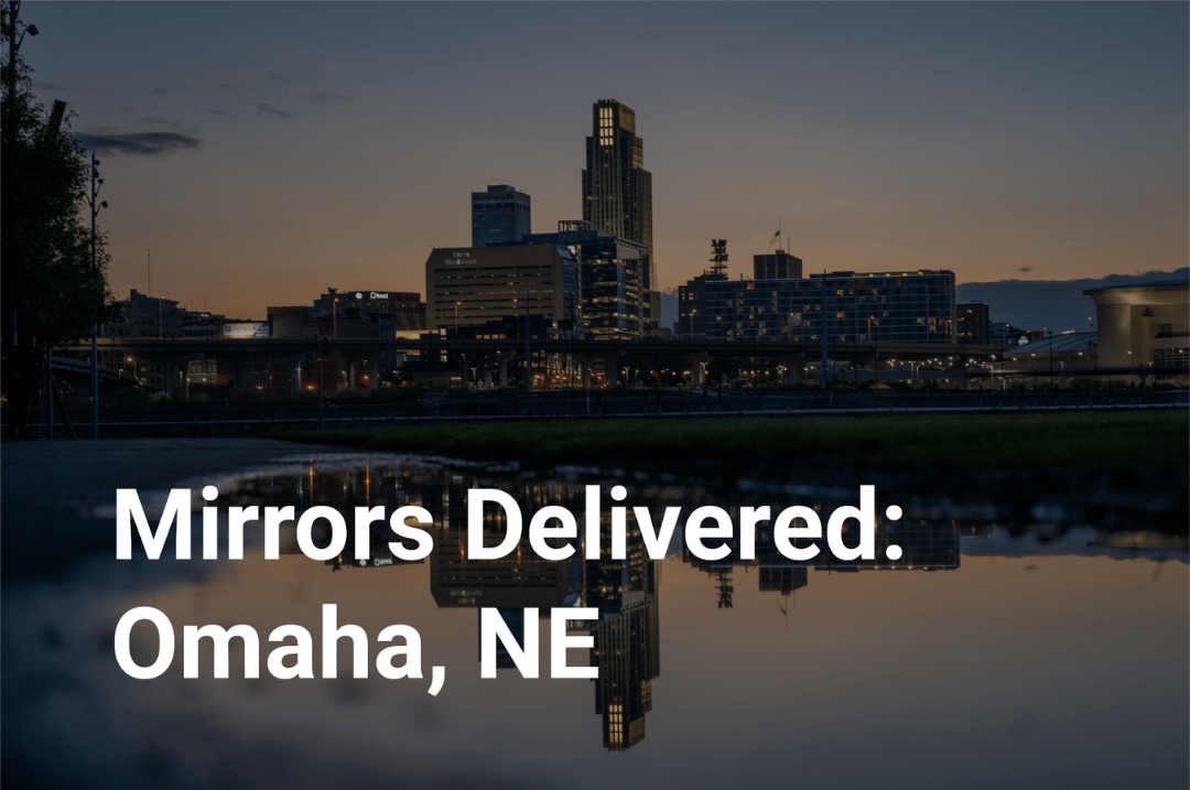 City skyline at dusk with text overlay 'Mirrors Delivered: Omaha, NE'.