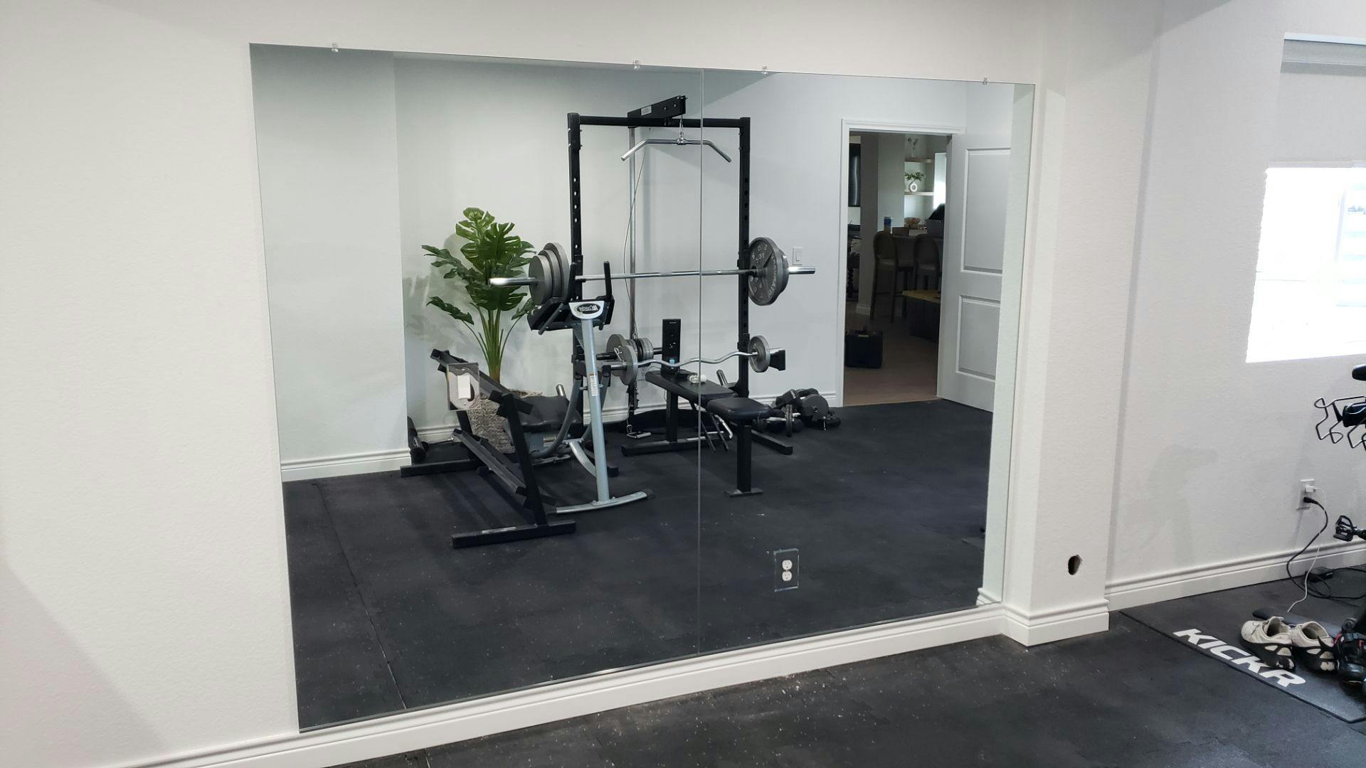 Shatter-resistant home gym mirror professionally mounted for daily use